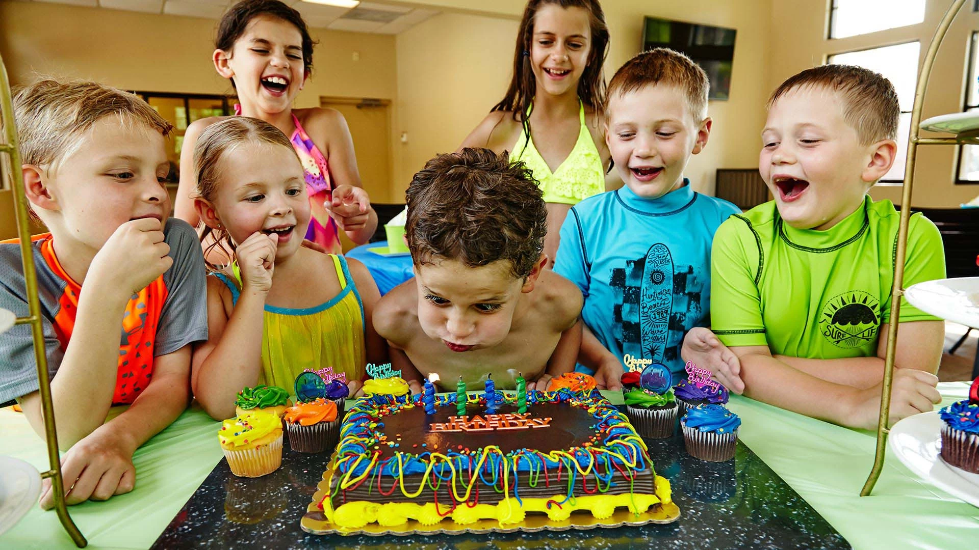 birthday boy blowing out birthday candles